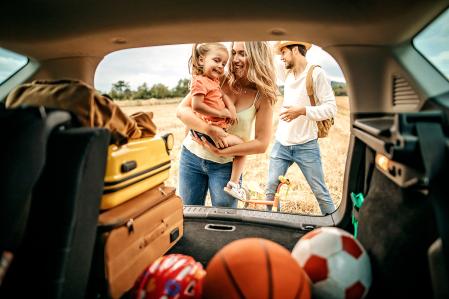 A family beside the car, heading to vacation
